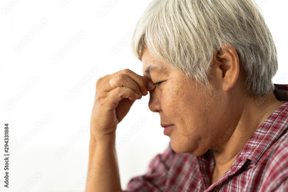 Senior adult elderly asia women serious depressed and feeling headache, thinking of problems on white background Senior adult elderly asia women serious depressed and feeling headache, thinking of problems on white background