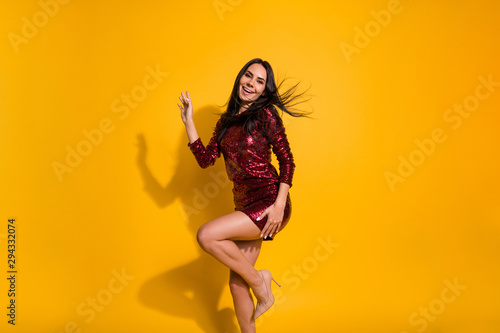 Profile photo of amazing lady with perfect slim shapes dancing like celebrity at disco party wear short shine red dress isolated yellow color background