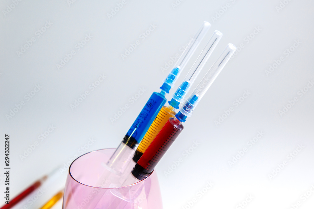 A set of medical syringes with color injections for cosmetology. The cocktail of the beautician for skin rejuvenation. A set of medical syringes with color injections for cosmetology. The cocktail of the beautician for skin rejuvenation.