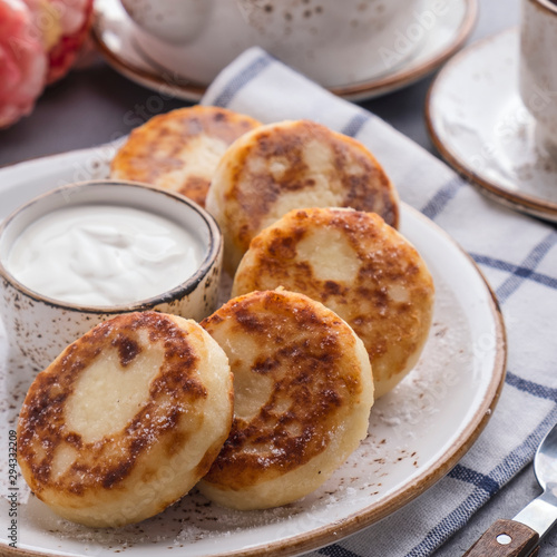 Curd pancakes with strawberry sauce on a plate