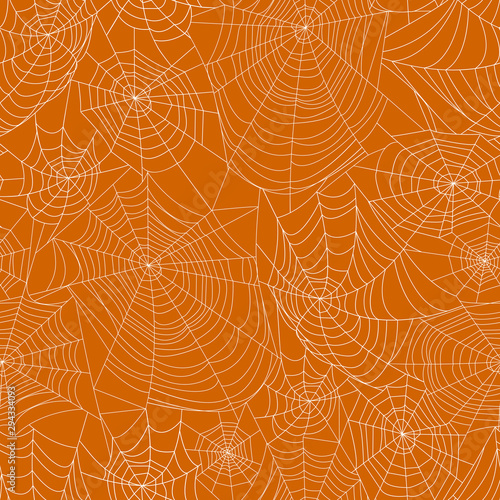 Spider webs on orange background. Seamless pattern. Halloween background