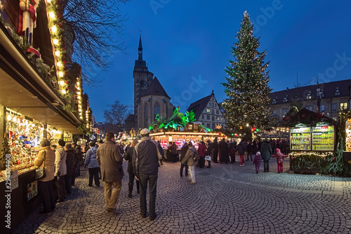 Stuttgart, Germany. Christmas market at Schillerplatz square close to Stiftskirche (Collegiate Church) and Altes Schloss (Old Castle) in dusk.