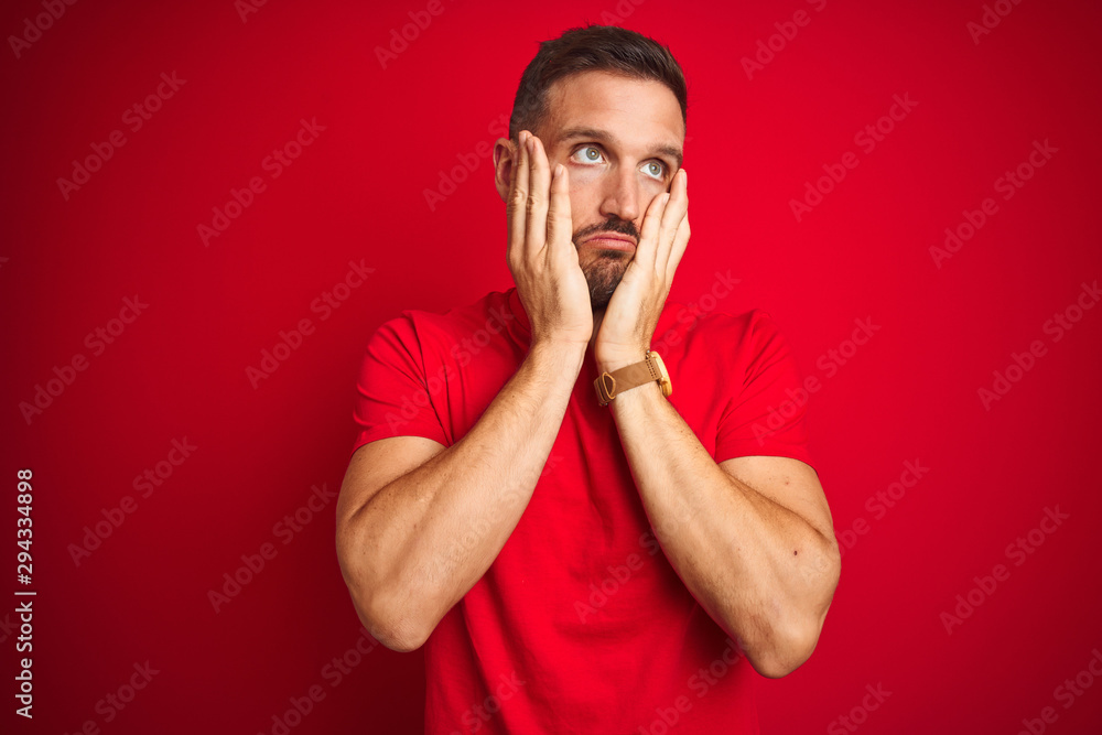 Young handsome man wearing casual t-shirt over red isolated background Tired hands covering face, depression and sadness, upset and irritated for problem Young handsome man wearing casual t-shirt over red isolated background Tired hands covering face, depression and sadness, upset and irritated for problem