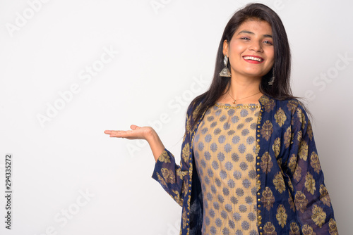 Obraz na plátne Happy young Persian woman showing something in traditional clothing