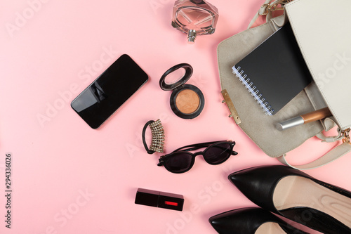Top view of Women bag and lady stuff with copyspace on pink background - Image