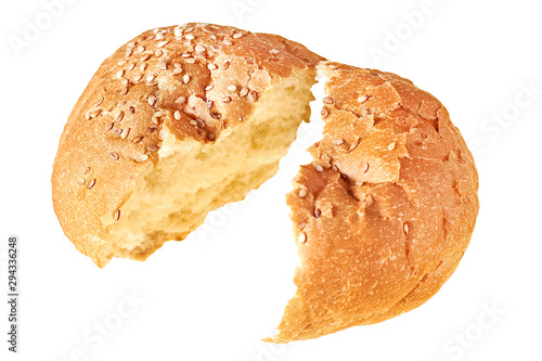 One broken tasty soft fresh round bun with sesame seeds for hamburger, cheeseburger or cooking other burgers. Isolated on white background. Close-up