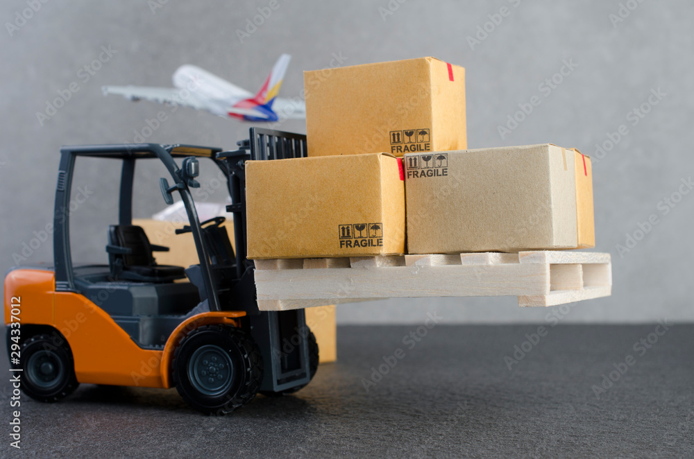 Forklift truck with boxes delivery and transportation logistics storage warehouse industry business commercial concept,logistic import export and transport industry background