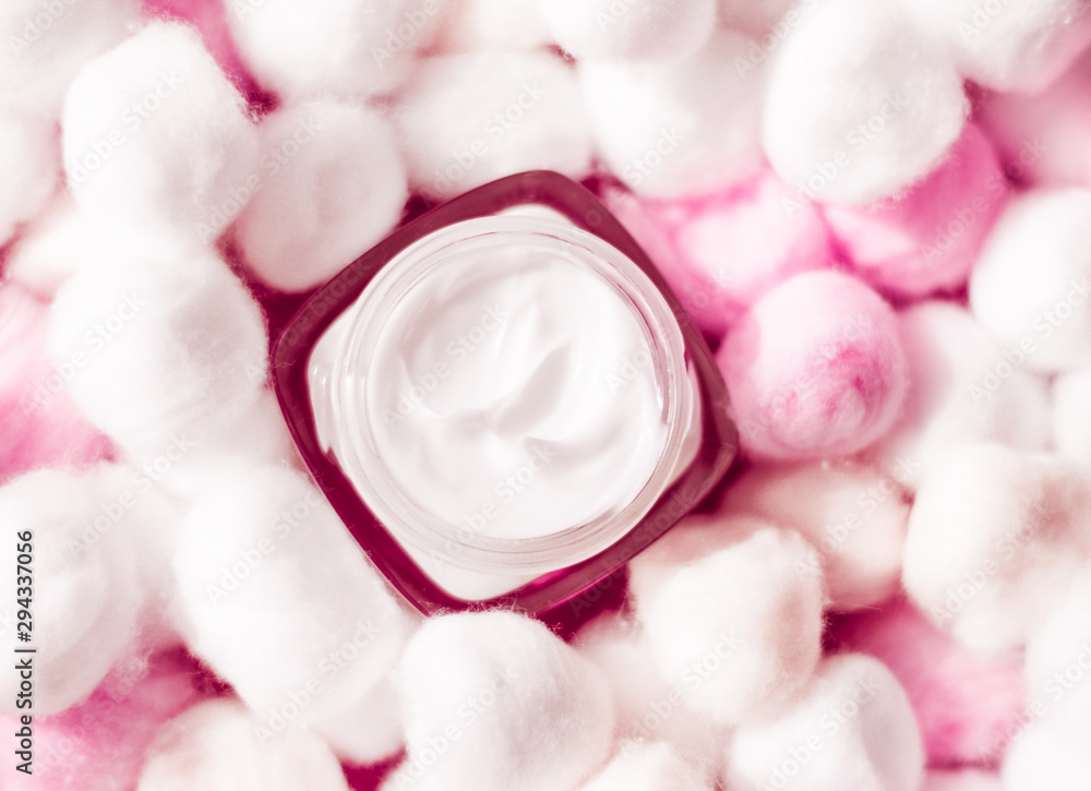 Luxury face cream for sensitive skin and pink cotton balls on background,  spa cosmetics and natural skincare beauty brand product, Stock image