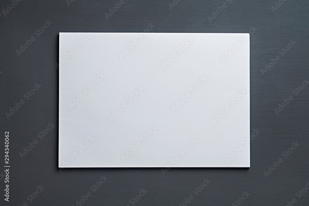 Single stack of blank white paper sheets lies on dark concrete table on workplace of secretary, director, boss or other worker of company. Space for text. Top view. Close-up Single stack of blank white paper sheets lies on dark concrete table on workplace of secretary, director, boss or other worker of company. Space for text. Top view. Close-up