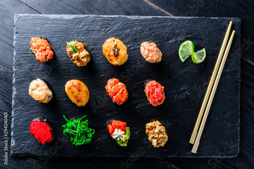 sushi set gunkans on a black background photo