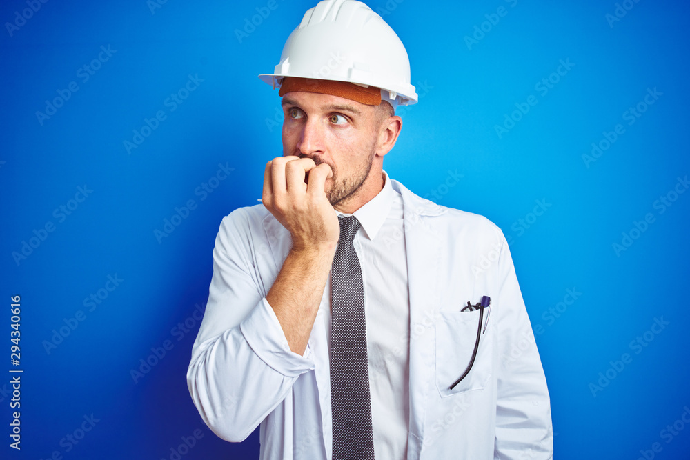 Young handsome engineer man wearing safety helmet over blue isolated background looking stressed and nervous with hands on mouth biting nails. Anxiety problem. Young handsome engineer man wearing safety helmet over blue isolated background looking stressed and nervous with hands on mouth biting nails. Anxiety problem.