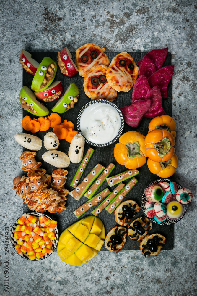 Halloween party food - selection of halloween style appetizers on rustic background