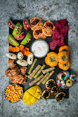 Halloween party food - selection of halloween style appetizers on rustic background