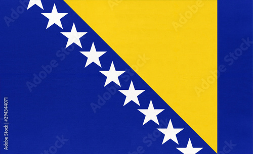 Fotografie Bosnia and Herzegovina national fabric flag textile background.