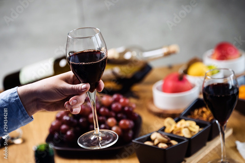 Pouring wine into glass and food background