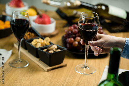 Pouring wine into glass and food background