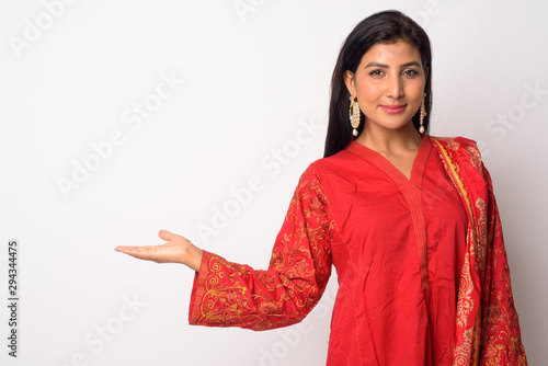 Young beautiful Persian woman showing something in traditional clothing