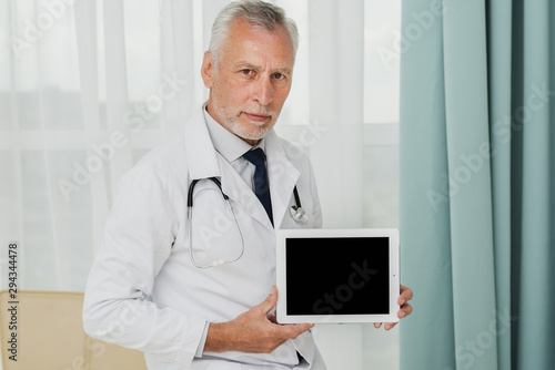 Mock-up doctor holding tablet