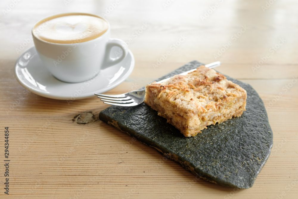 cup of cappuccino with a piece of cake. cup of cappuccino with a piece of cake.