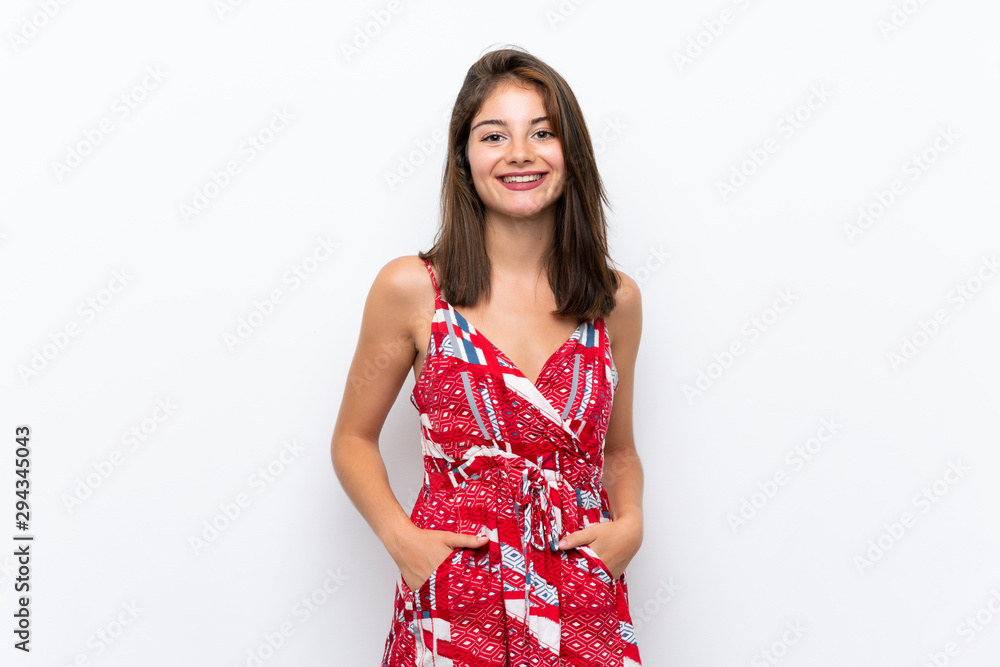 Caucasian girl in red dress over isolated white wall laughing
