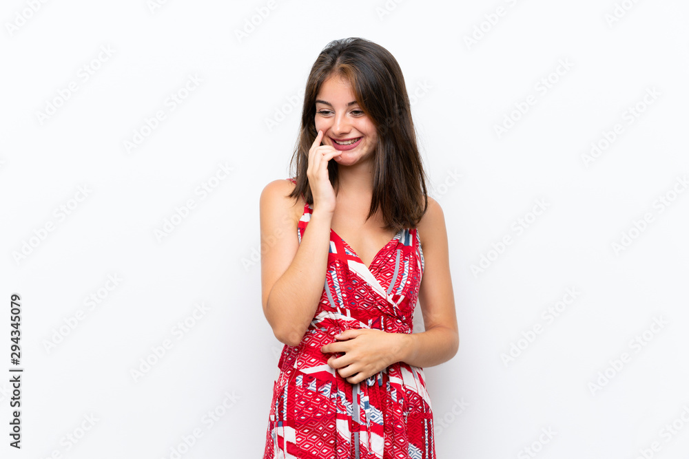 Caucasian girl in red dress over isolated white wall smiling a lot Caucasian girl in red dress over isolated white wall smiling a lot