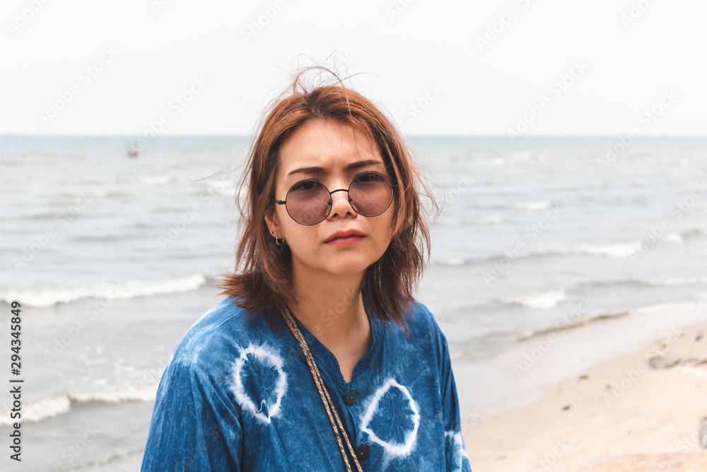 Young Asian adult relax aat the beach with blur background. Young Asian adult relax aat the beach with blur background.