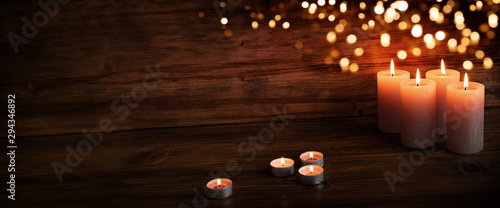 Burning candles in darkness photo