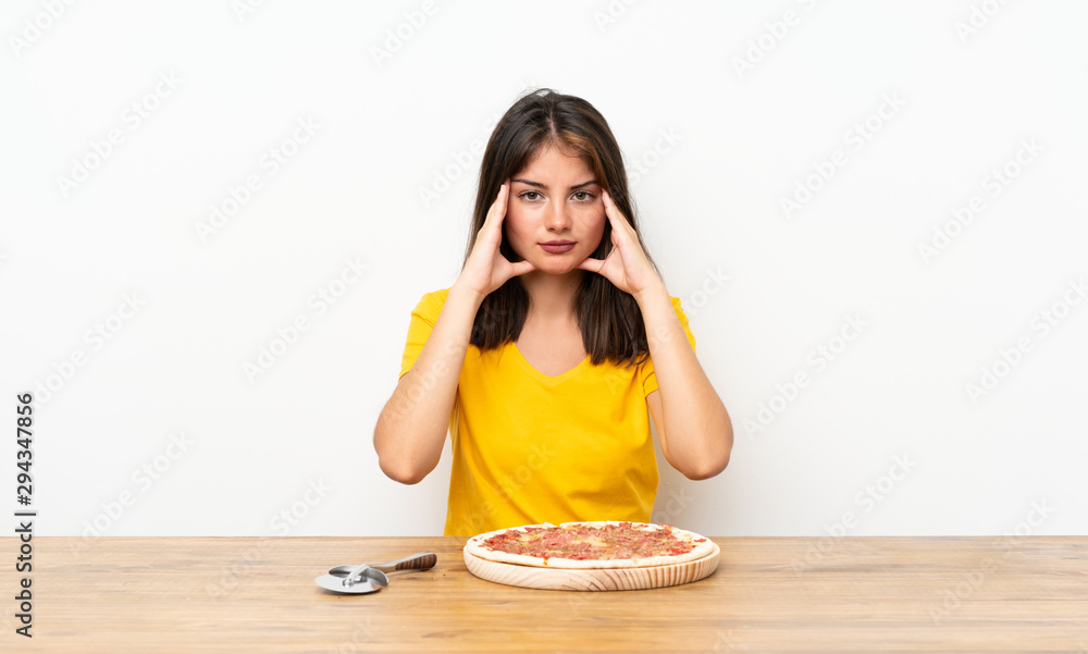 Caucasian girl with a pizza unhappy and frustrated with something. Negative facial expression Caucasian girl with a pizza unhappy and frustrated with something. Negative facial expression