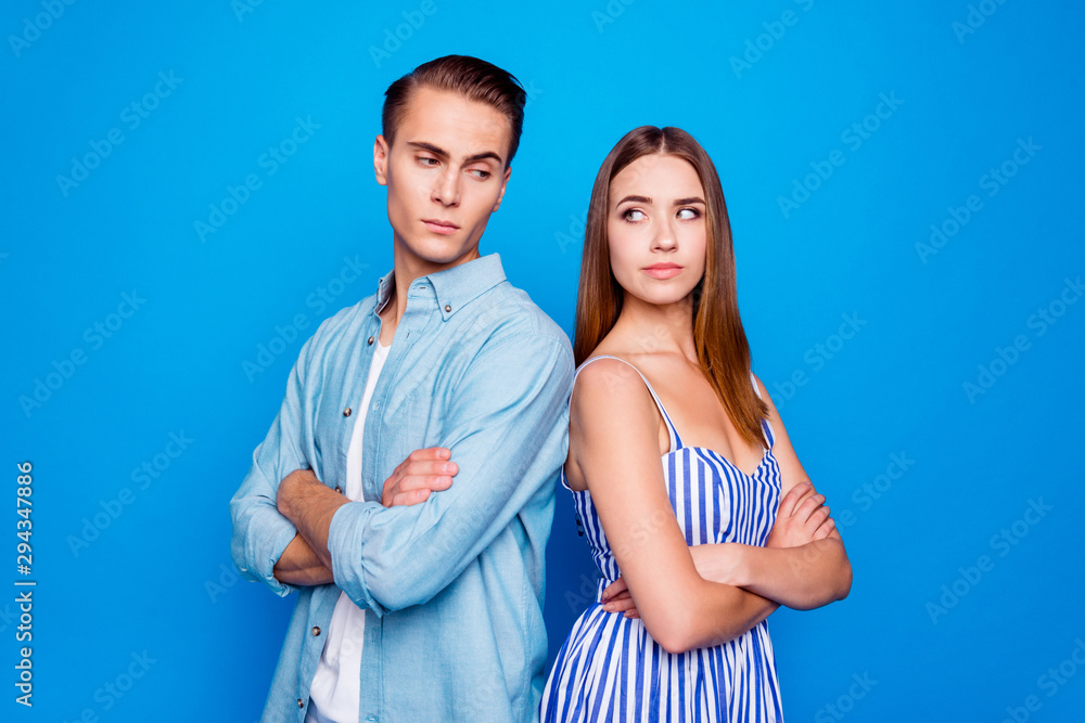 Profile side view portrait of two nice attractive doubtful suspicious focused discontent people looking at each other folded arms isolated over bright vivid shine vibrant blue color background Profile side view portrait of two nice attractive doubtful suspicious focused discontent people looking at each other folded arms isolated over bright vivid shine vibrant blue color background