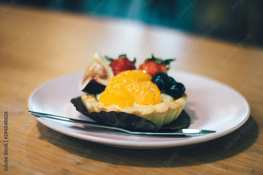 Close up of fruit tart on the wooden table. Close up of fruit tart on the wooden table.