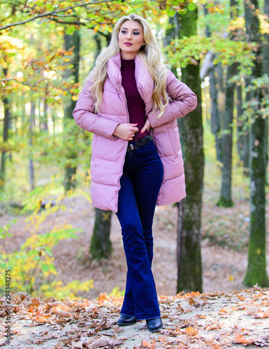 Outfit prove puffer coat can look stylish. Girl fashionable blonde walk in park. Jackets everyone should have. Best puffer coats to buy. How to rock puffer jacket like star. Puffer fashion concept © be free