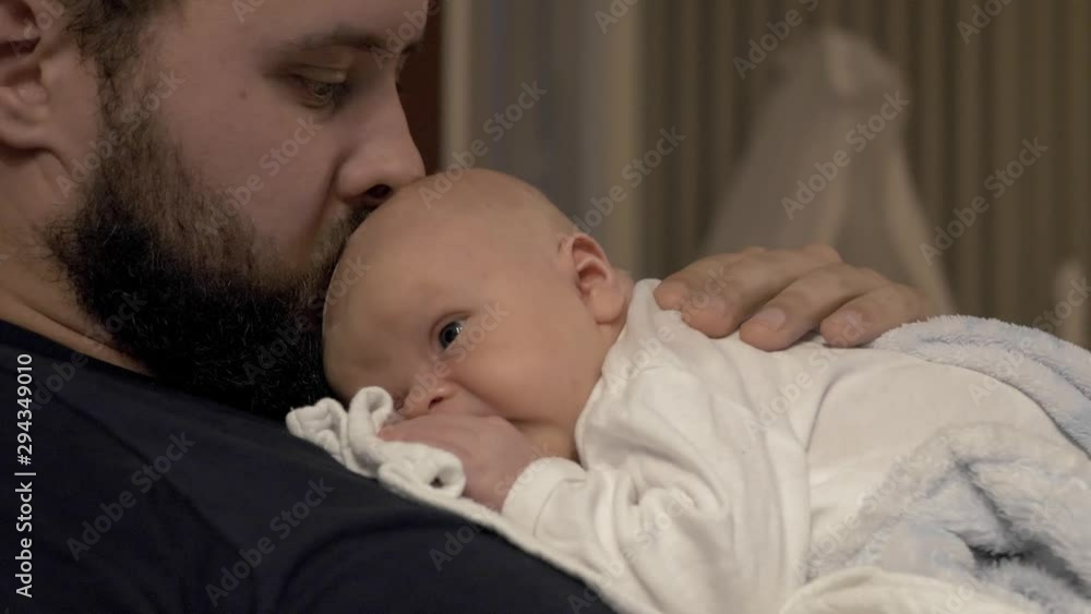 Dad lying comfortably with newborn baby son, bonding together with affection. Dad lying comfortably with newborn baby son, bonding together with affection.