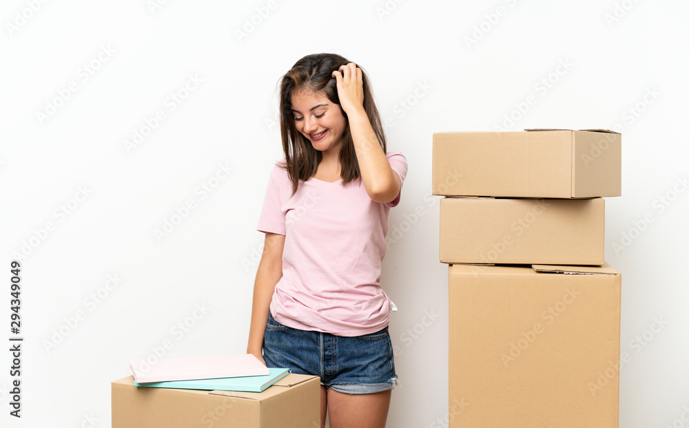 Young girl moving in new home among boxes laughing Young girl moving in new home among boxes laughing
