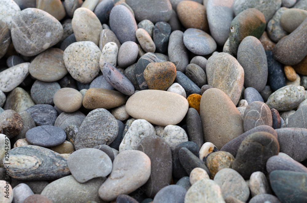 Pebbles on the beach: gray, white and purple stones Pebbles on the beach: gray, white and purple stones