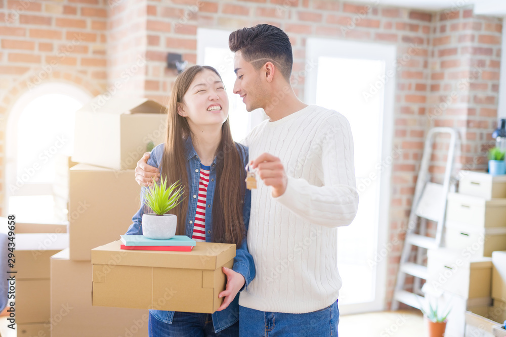 Young asian couple holding keys of new house, smiling happy and excited moving to a new apartment Young asian couple holding keys of new house, smiling happy and excited moving to a new apartment
