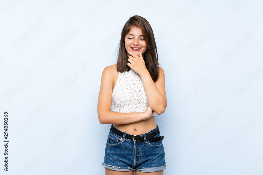 Young woman over isolated blue background looking to the side Young woman over isolated blue background looking to the side