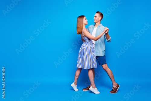 Full length body size view of her she his he two nice-looking attractive charming cheerful people dancing waltz isolated over bright vivid shine vibrant blue turquoise color background