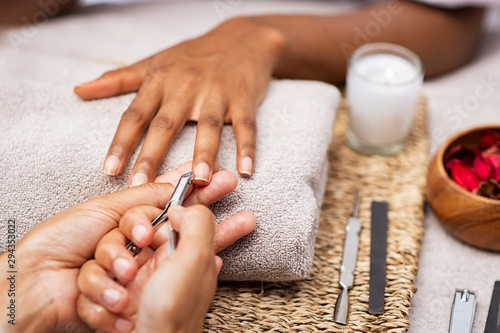 Woman clipping nails at salon