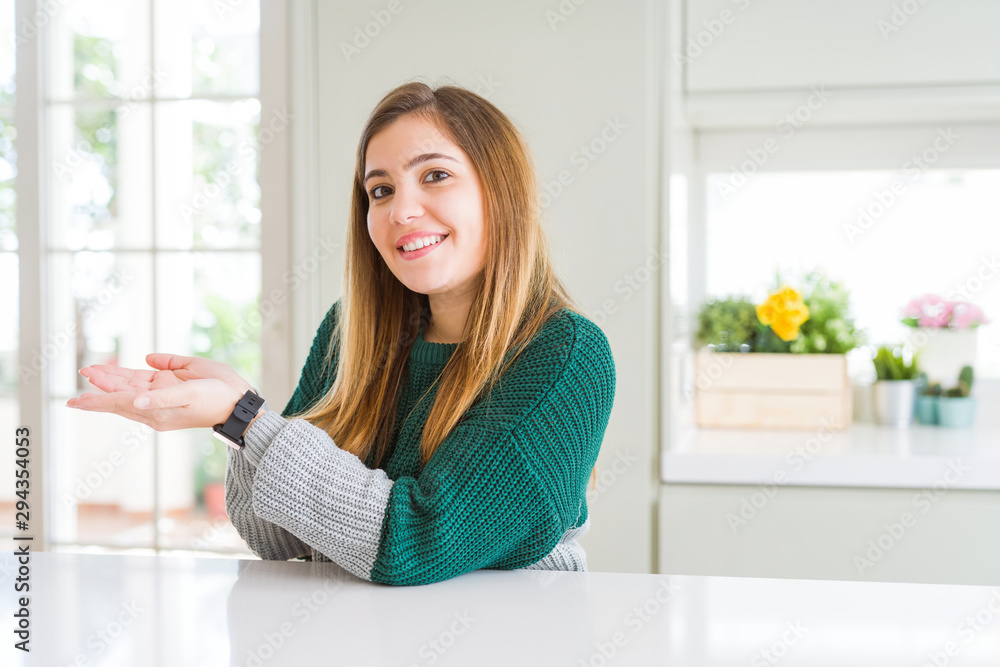 Young beautiful plus size woman wearing casual striped sweater pointing aside with hands open palms showing copy space, presenting advertisement smiling excited happy Young beautiful plus size woman wearing casual striped sweater pointing aside with hands open palms showing copy space, presenting advertisement smiling excited happy