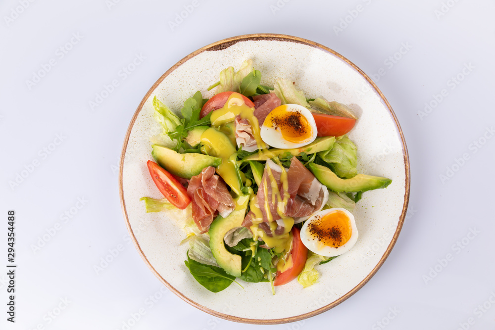 Healthy breakfast. Salad with prosciutto, tomato, egg, avocado Healthy breakfast. Salad with prosciutto, tomato, egg, avocado