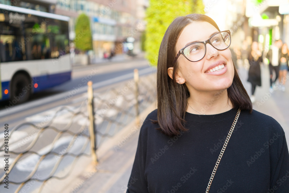 Beautiful young brunette woman smiling excited walking down the city streets, happy and confident expression standing outdoors at the town Beautiful young brunette woman smiling excited walking down the city streets, happy and confident expression standing outdoors at the town