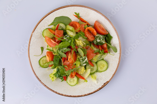 Various fresh mix salad with salmon, tomato, cucumber, onion, bell pepper, healthy food and diet menu.