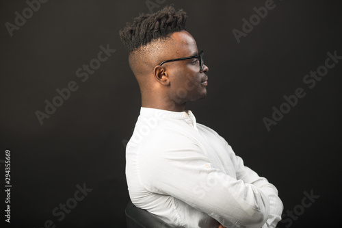handsome african man in glasses on black