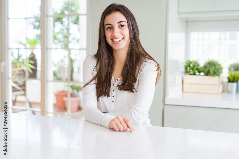 Beautiful young brunette woman smiling cheerful looking at the camera with a big smile on face showing teeth Beautiful young brunette woman smiling cheerful looking at the camera with a big smile on face showing teeth