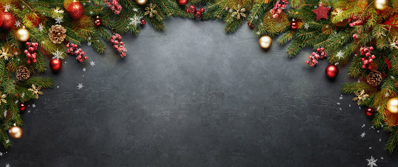 Christmas or New Year banner. Xmas presents with decoration and fir branches on black background.