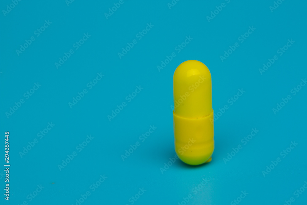 Yellow pills on blue background Yellow pills on blue background