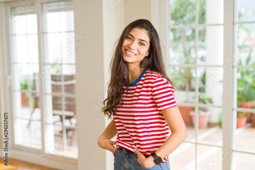 Beautiful brunette woman smiling cheerful, looking happy and positive