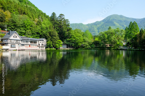 Landscape of The Kinrin Lake with surrounded by trees in Background and water reflection, onsen town, Yufuin, Oita, Kyushu, Japan.
