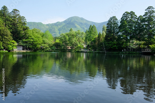 Landscape of The Kinrin Lake with surrounded by trees in Background and water reflection, onsen town, Yufuin, Oita, Kyushu, Japan.