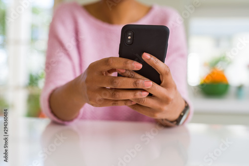 Close up of african american woman using smartphone and smiling
